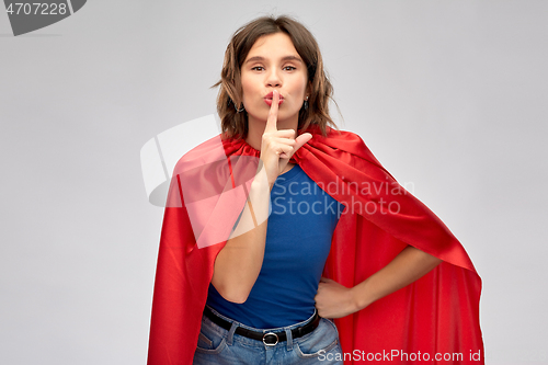 Image of happy woman in red superhero cape