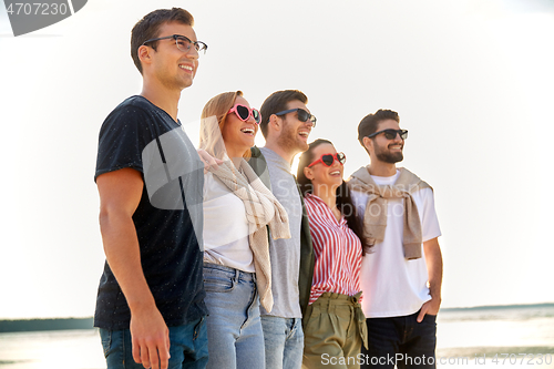 Image of happy friends on summer beach