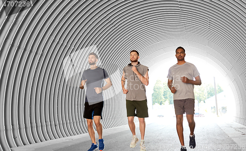 Image of young men or male friends running outdoors