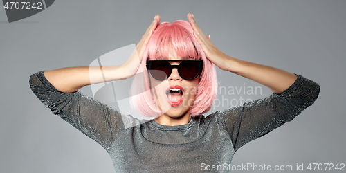 Image of happy woman in pink wig and black sunglasses