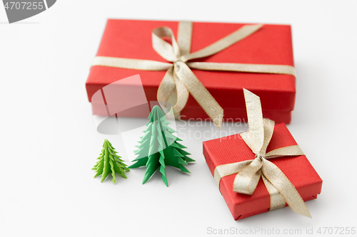 Image of gift boxes and christmas trees on white background