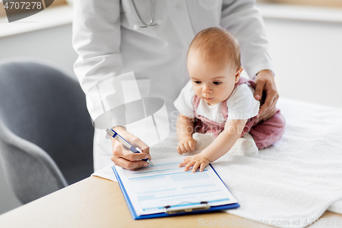 Image of female pediatrician doctor with baby at clinic