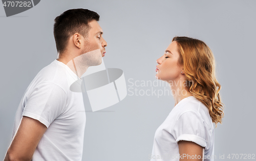 Image of couple in white t-shirts ready for kiss