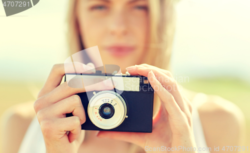 Image of close up of woman photographing with film camera