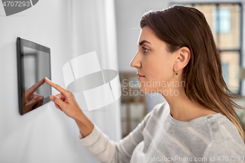 Image of woman using tablet computer at smart home