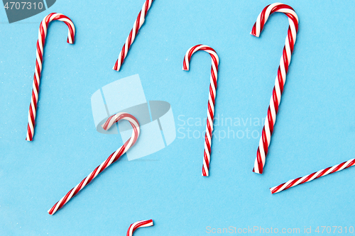 Image of candy cane decorations on blue background