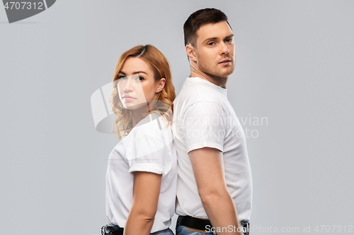 Image of portrait of sad couple in white t-shirts