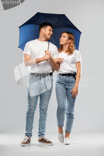 Image of happy couple in white t-shirts with umbrella