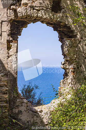 Image of View through old abandoned dilapidated building on the blue seas