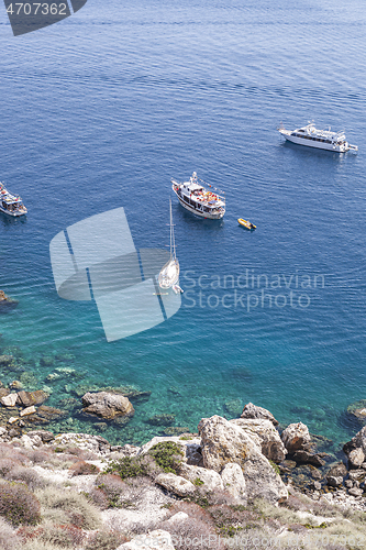 Image of View of the Tremiti Islands. Boats near a rock stone coast. 