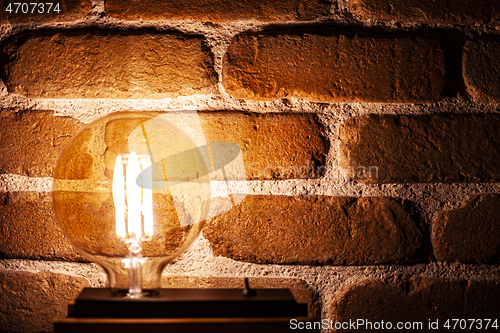 Image of Illuminated grunge red brick wall background.