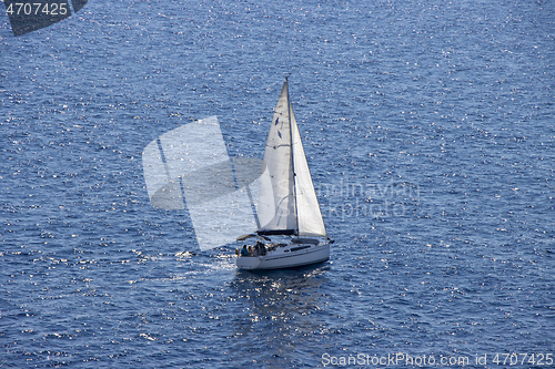 Image of Sailingboat with white sails at opened sea