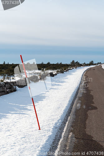 Image of Red snow stake by roadside