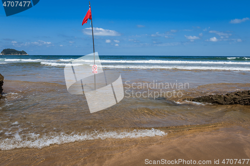 Image of Red flag on the beach. Swimming and surfing ban.