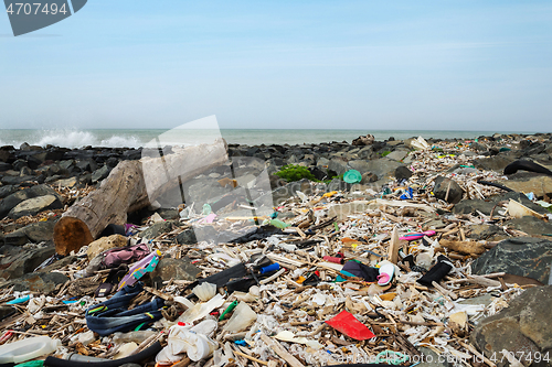 Image of Spilled garbage on the beach near the big city. Empty used dirty plastic bottles and other garbage. Environmental pollution. Ecological problem.