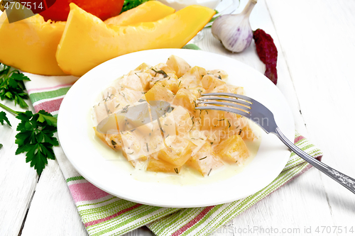 Image of Pumpkin with sour cream sauce in plate on white wooden board