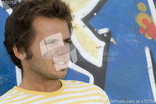 Image of Man next to a graffiti wall