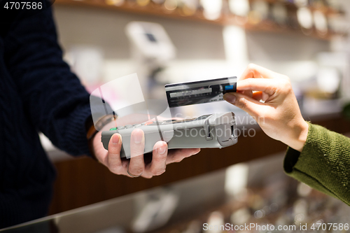 Image of Customer pay by NFC at shop