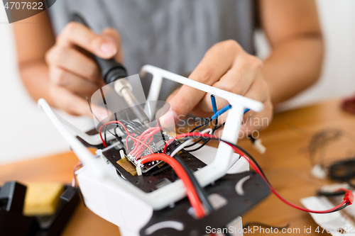 Image of Man welding on the borad of drone