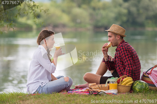 Image of Couple in love enjoying picnic time