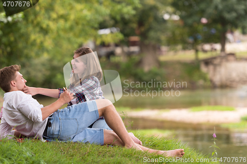 Image of Couple in love enjoying picnic time