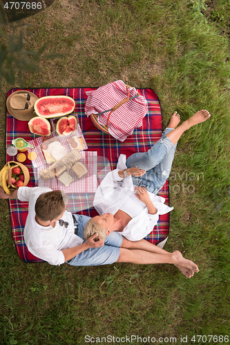 Image of top view of couple enjoying picnic time