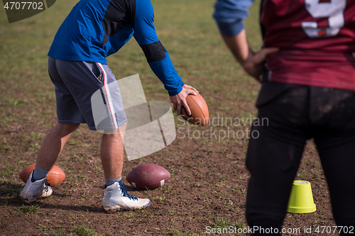 Image of american football team with coach in action