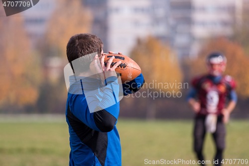 Image of american football team with coach in action