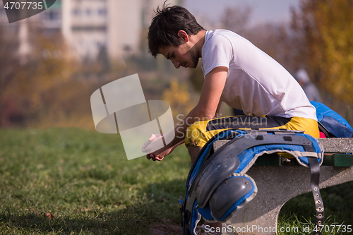 Image of american football player resting after hard training