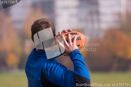 Image of american football team with coach in action