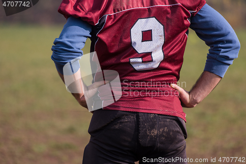 Image of american football player resting after hard training