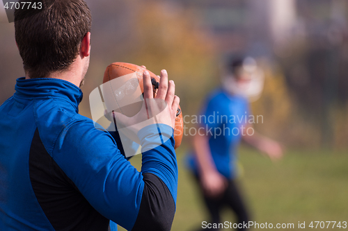 Image of american football team with coach in action