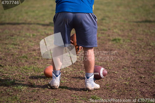 Image of american football kicker practicing kickoff