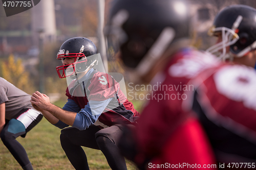 Image of american football players stretching and warming up