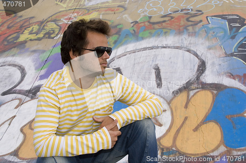 Image of men next to a graffiti wall