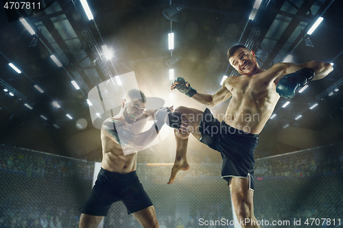 Image of Two professional boxers boxing on the ring