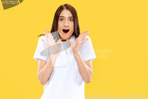 Image of Portrait of beautiful woman isolated on yellow studio background