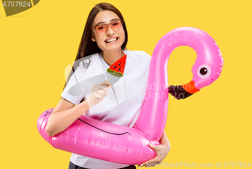 Image of Portrait of beautiful woman isolated on yellow studio background