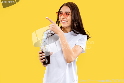 Image of Portrait of beautiful woman isolated on yellow studio background