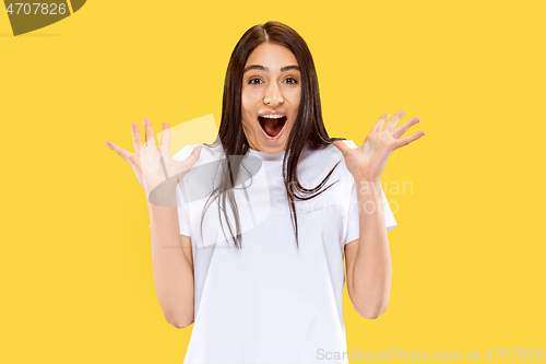 Image of Portrait of beautiful woman isolated on yellow studio background