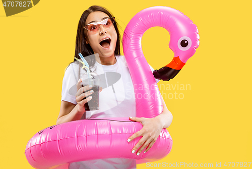 Image of Portrait of beautiful woman isolated on yellow studio background