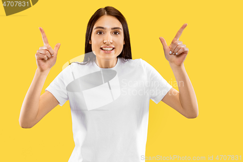 Image of Portrait of beautiful woman isolated on yellow studio background