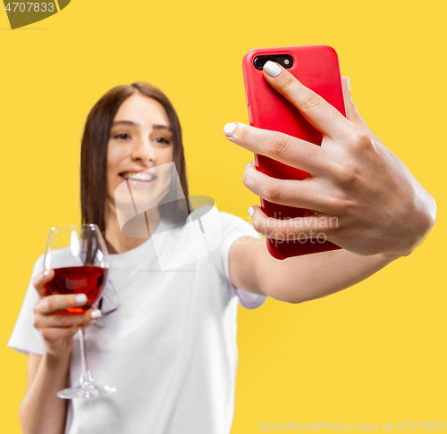 Image of Portrait of beautiful woman isolated on yellow studio background