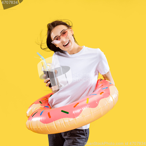 Image of Portrait of beautiful woman isolated on yellow studio background