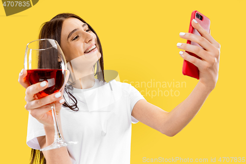 Image of Portrait of beautiful woman isolated on yellow studio background