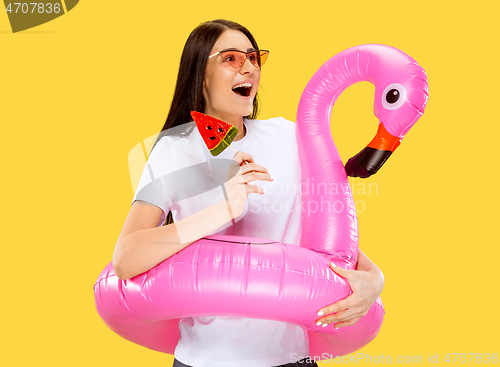 Image of Portrait of beautiful woman isolated on yellow studio background