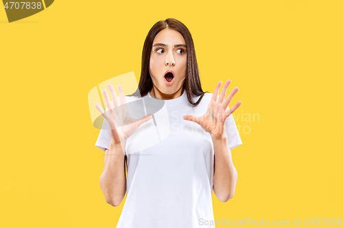 Image of Portrait of beautiful woman isolated on yellow studio background