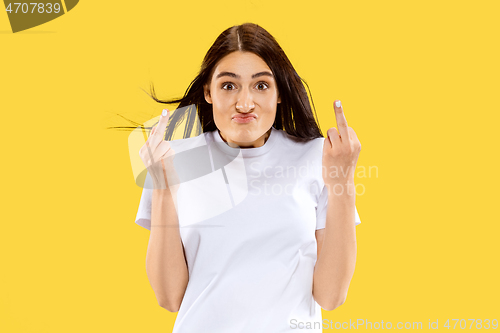 Image of Portrait of beautiful woman isolated on yellow studio background