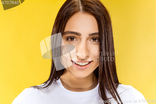 Image of Portrait of beautiful woman isolated on yellow studio background