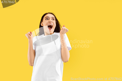 Image of Portrait of beautiful woman isolated on yellow studio background